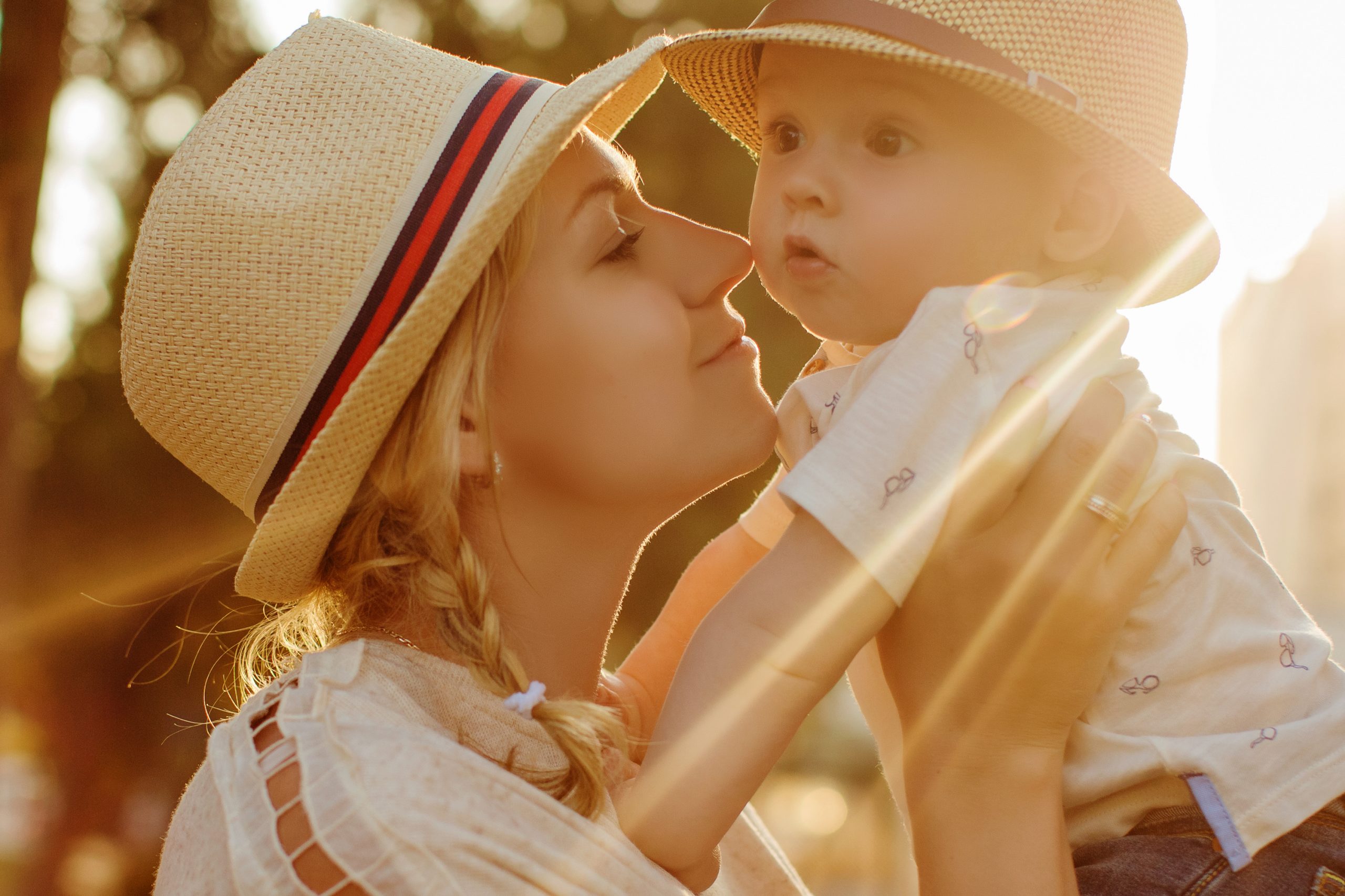 Beautiful,Blonde,In,A,Hat,Mother,Kissing,Her,Son,At